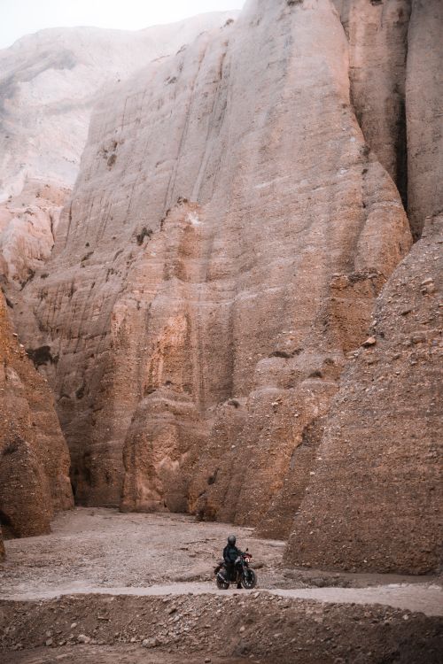 Free A lone motorcyclist explores the rugged Mustang canyons in Nepal. Stock Photo