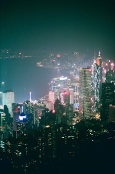 Stunning aerial view of Hong Kong's vibrant cityscape illuminated at night.
