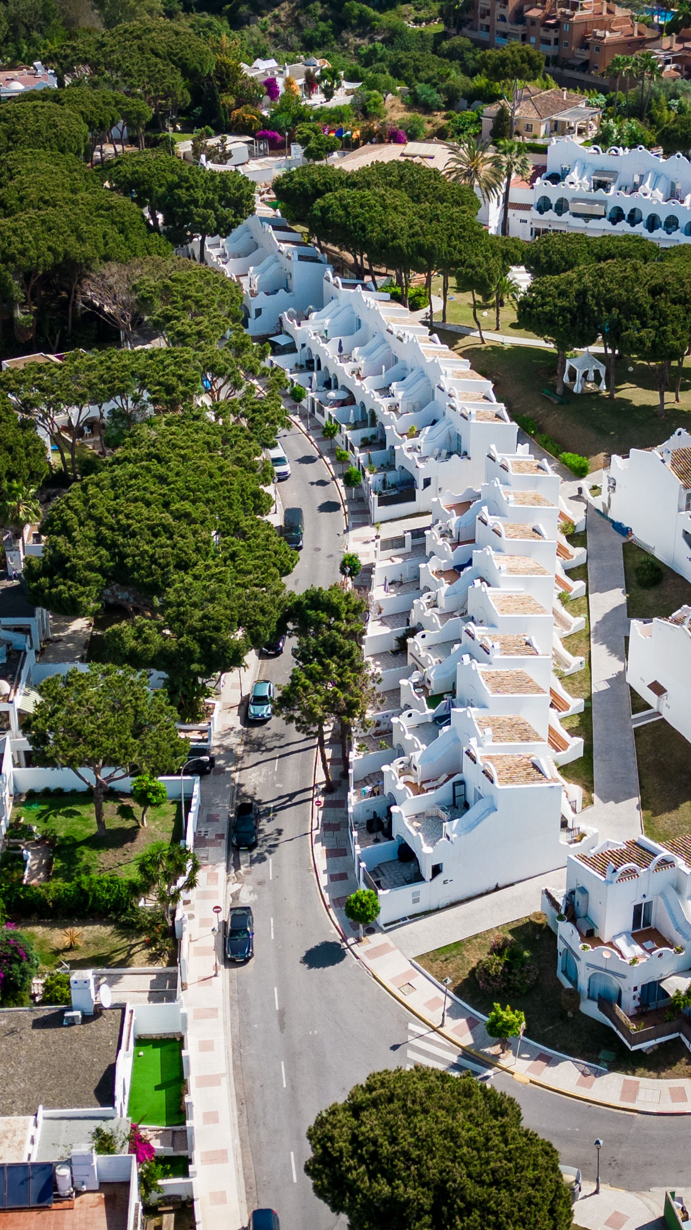 White townhouses and shared landscaped surroundings in Marbella