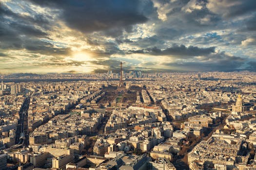 Stunning aerial shot of Paris at dawn with the Eiffel Tower in view.