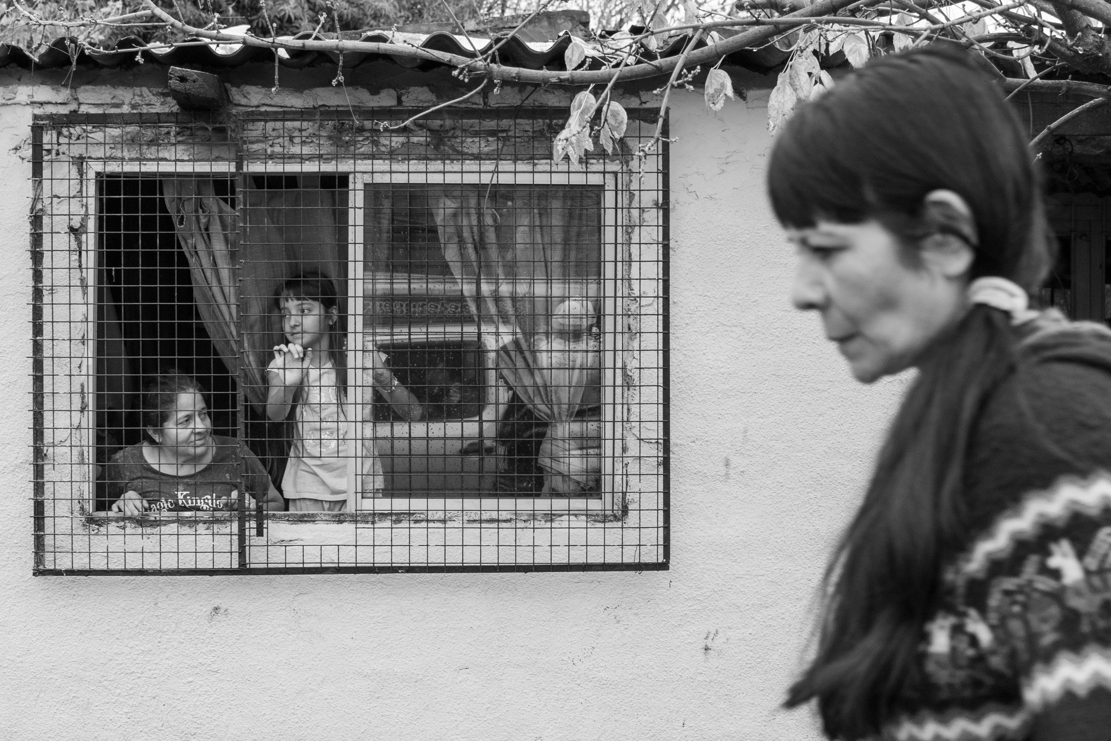 A poignant image of families seen through a window, highlighting community and resilience.
