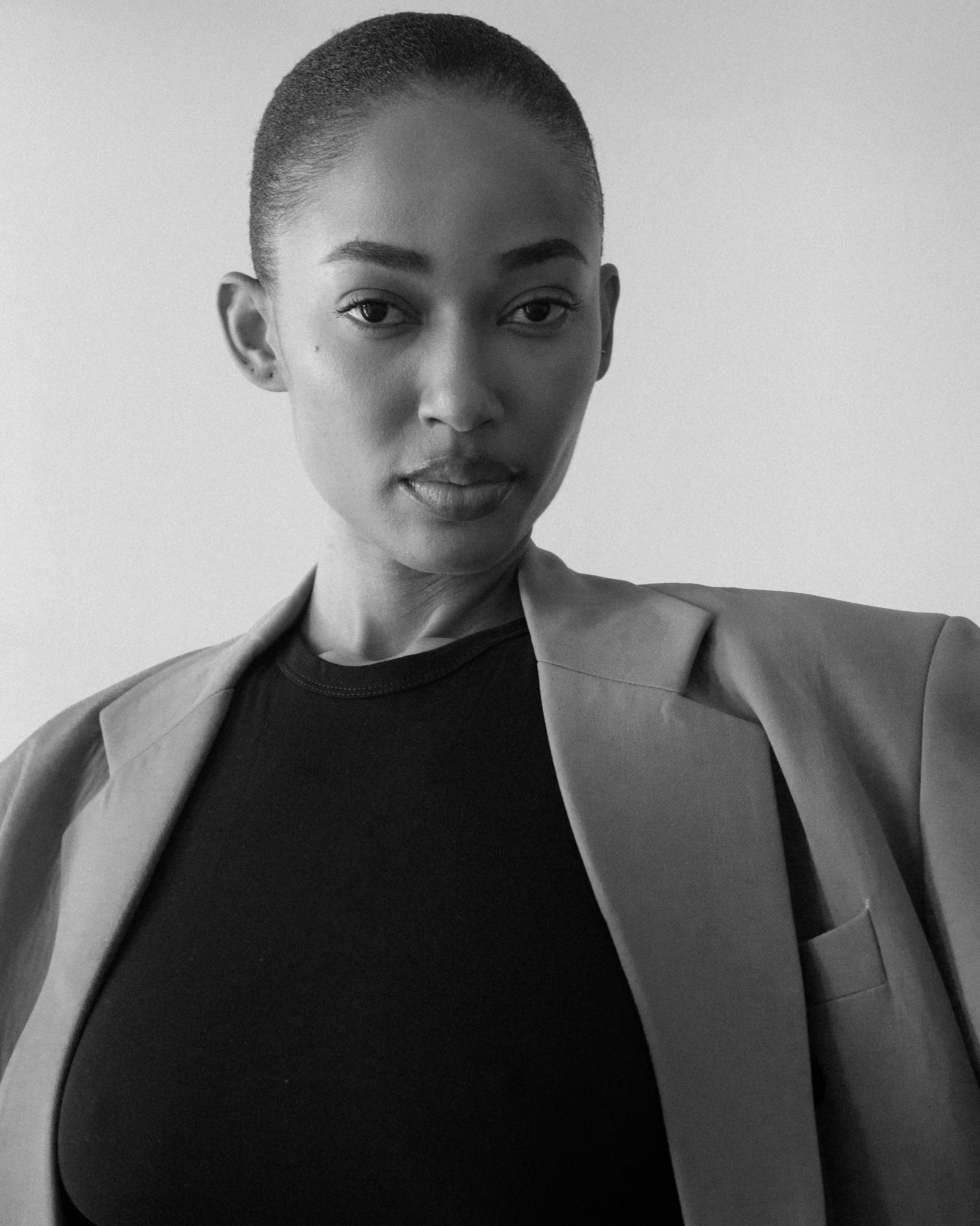 Striking black and white portrait of a female model exuding elegance and confidence.