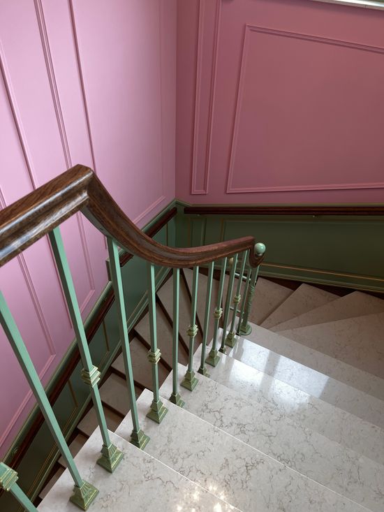 Pastel staircase with a green railing — photo by sparkle light on Pexels