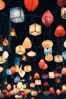 Vibrant display of traditional lanterns hanging in a Guilin market, capturing a lively night scene in China.