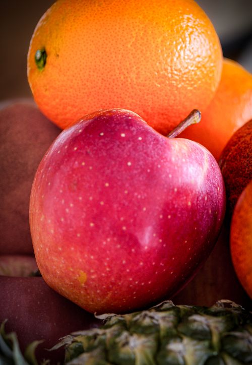 Free A close-up of colorful fresh fruits including apple, orange, and pineapple. Stock Photo