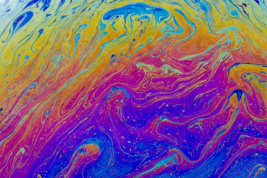 Colorful abstract liquid art with swirling vibrant hues creating a psychedelic texture.