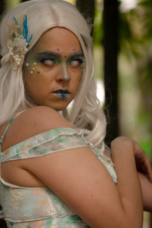 Free A mesmerizing woman with artistic makeup poses outdoors in a fantasy costume. Stock Photo