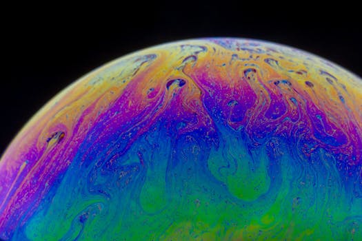 Colorful abstract pattern with iridescent colors on a soap bubble surface.