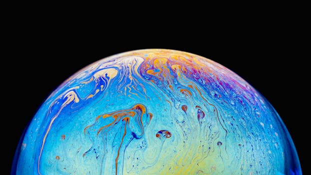 Macro shot of a colorful, iridescent soap bubble surface with swirling patterns against a black background.