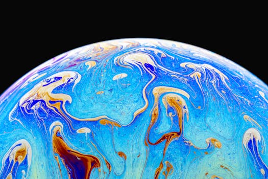 Vibrant abstract image of a soap film displaying flowing iridescent patterns and vivid colors.