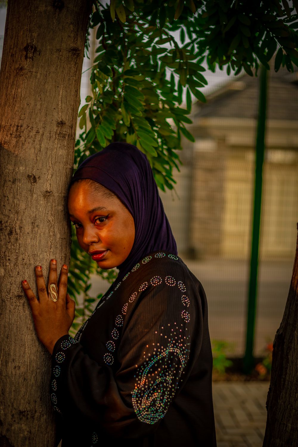 Portrait of Woman in Hijab Leaning Against Tree · Free Stock Photo