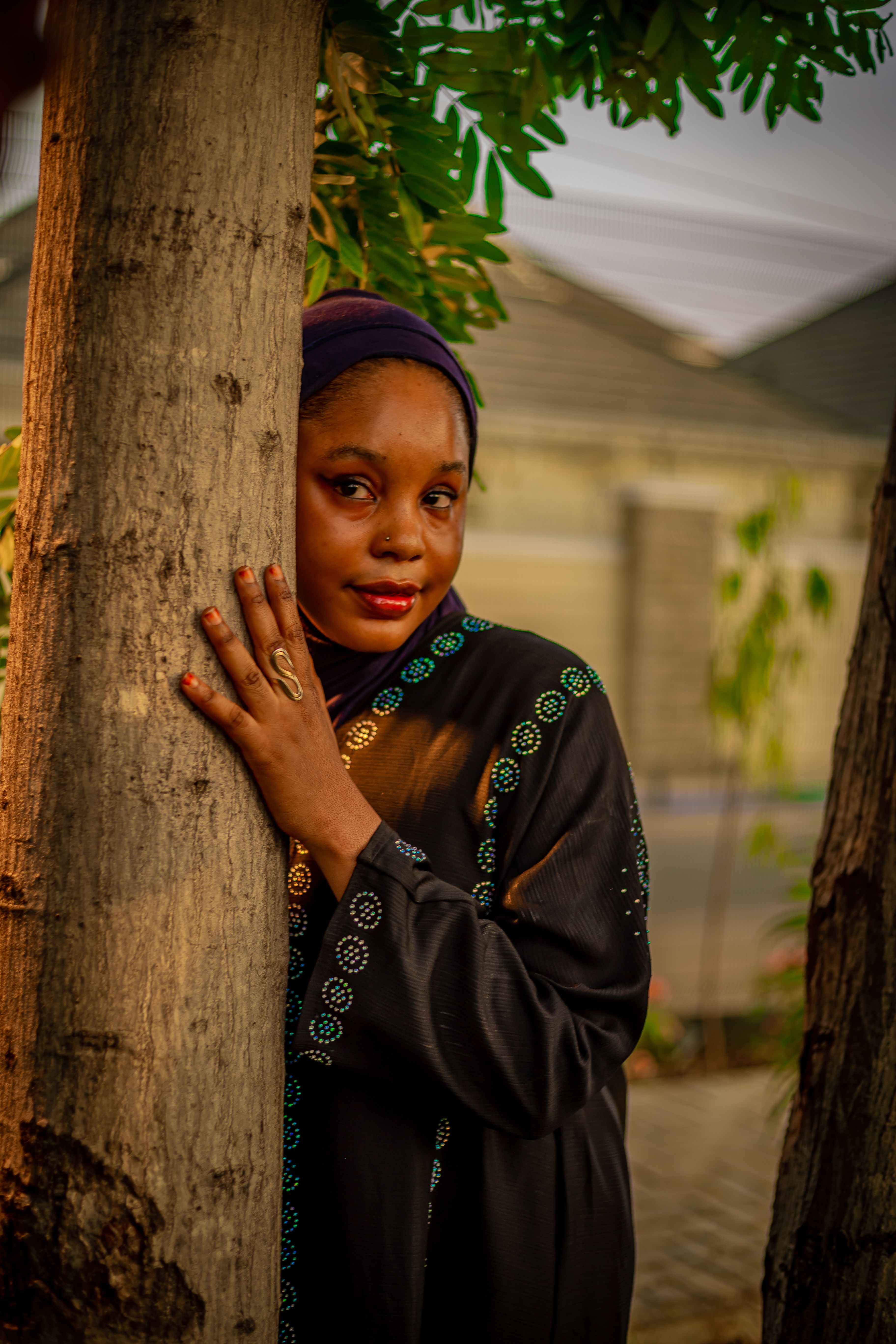 Young Woman in Traditional Attire Under a Tree · Free Stock Photo