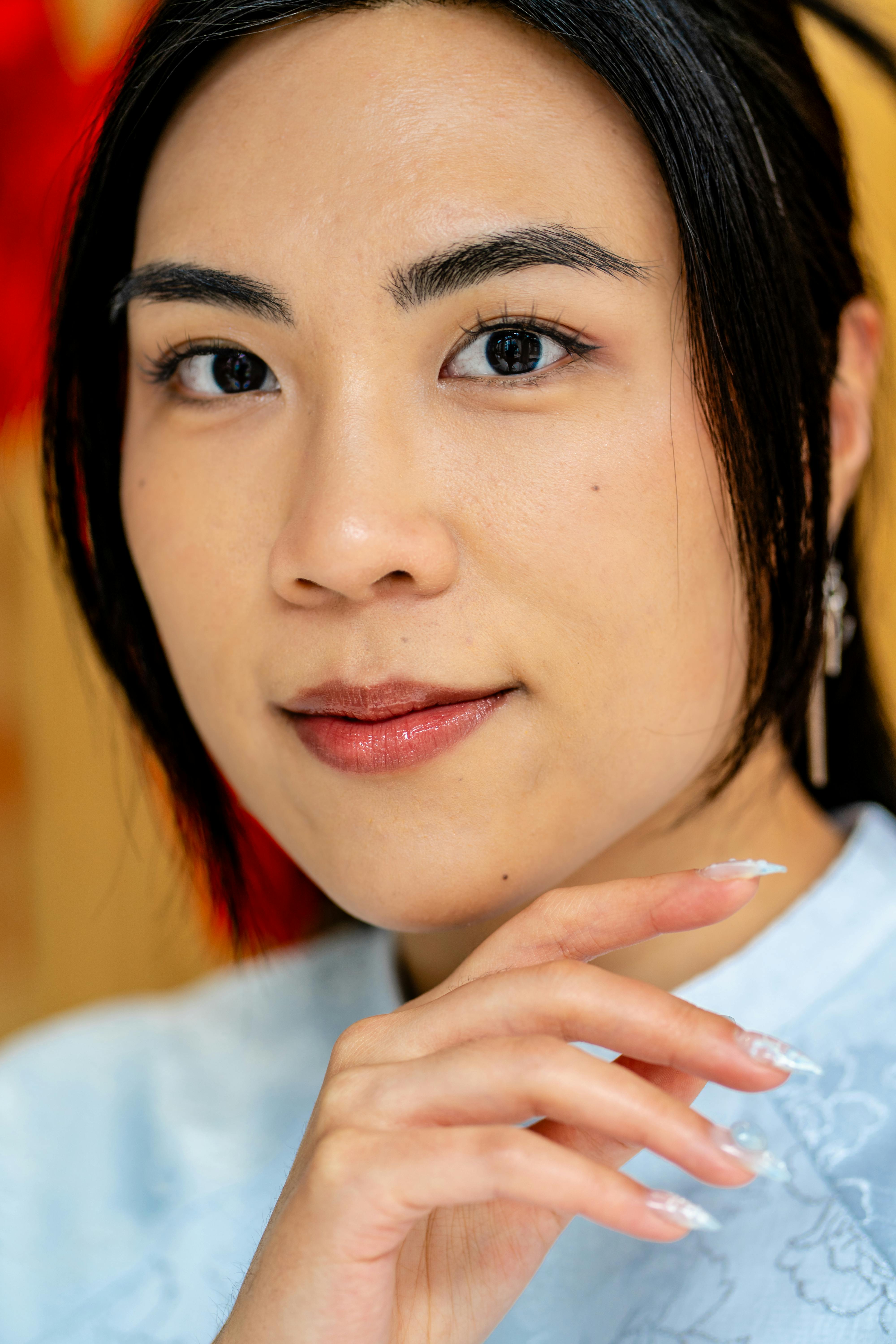 Close-up portrait of an Asian woman in traditional attire, showcasing elegance and beauty.