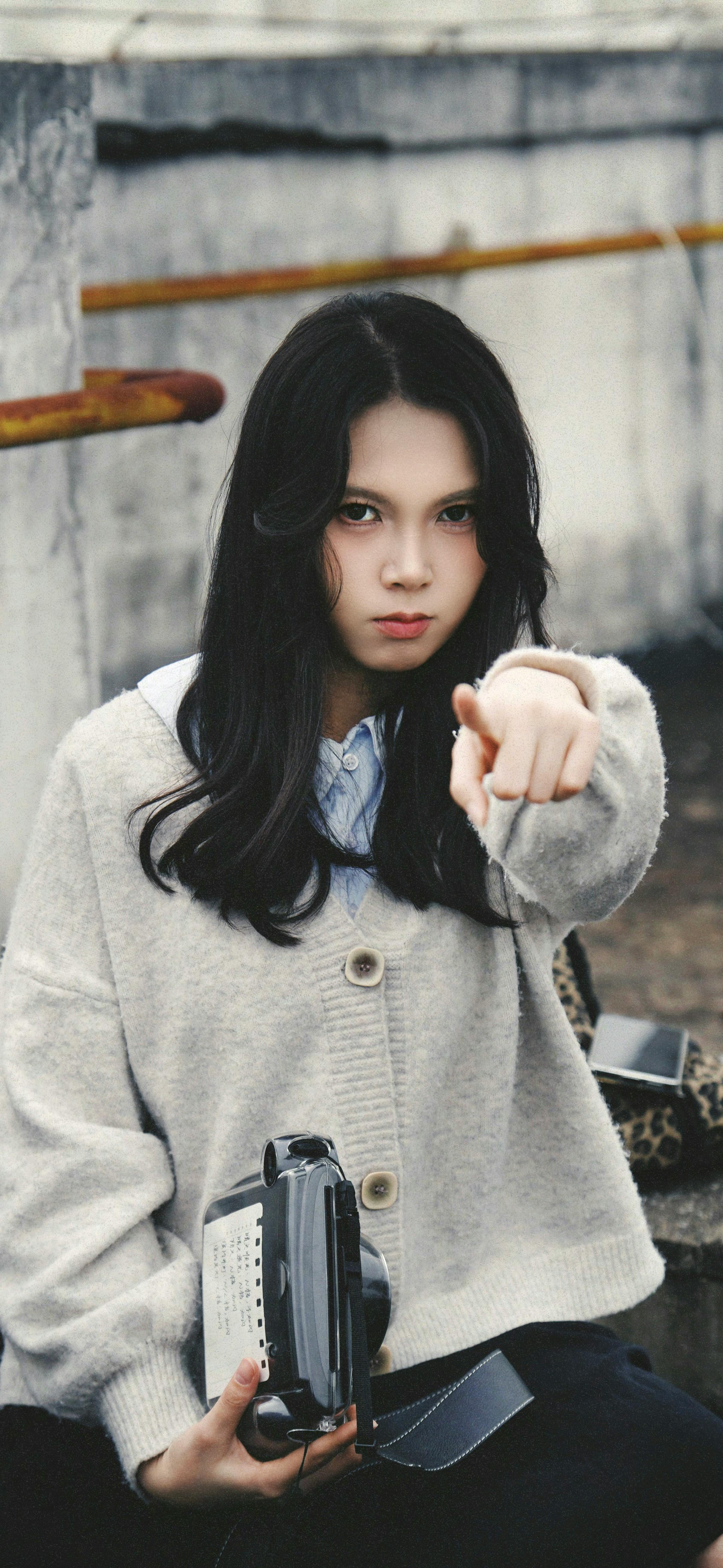 Young Woman Holding Camera Outdoors