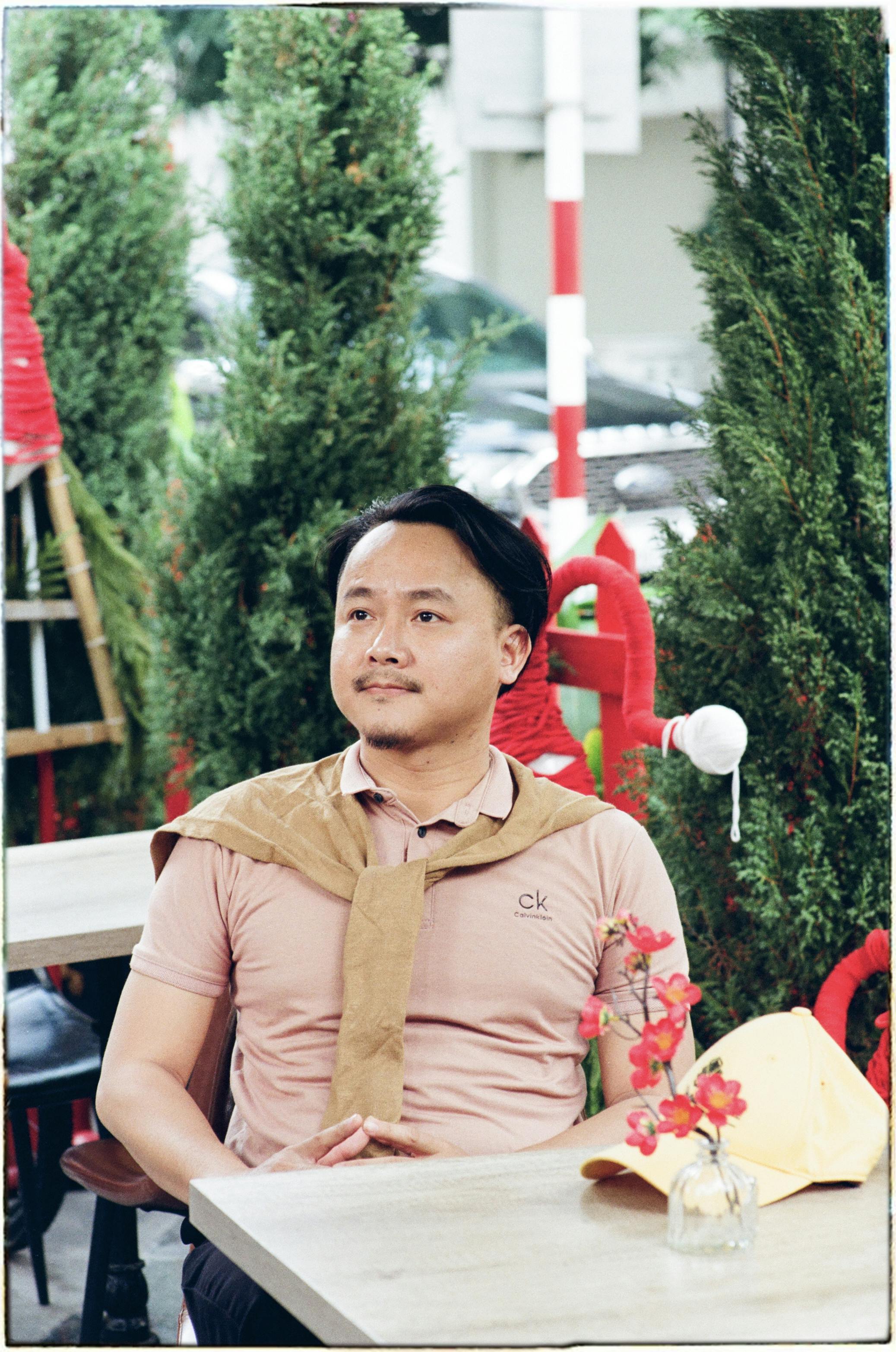 Asian man enjoying a peaceful moment in an outdoor café in Hanoi, Vietnam.