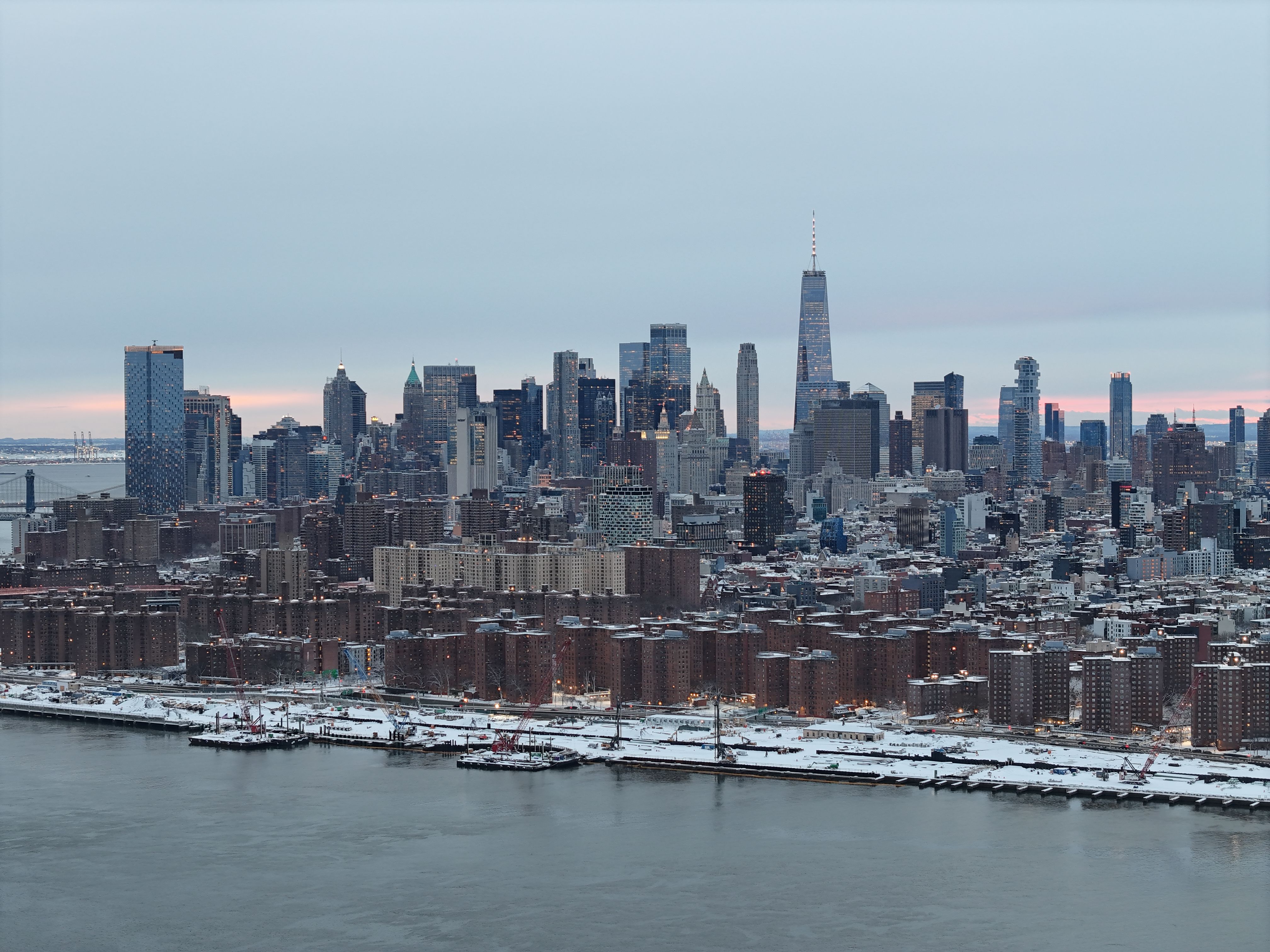 Spectacular 10-Minute Helicopter Transfer from Manhattan to Newark Airport Review Review 2026 - A stunning aerial shot of the Manhattan skyline under snow during winter, showcasing iconic skyscrapers.