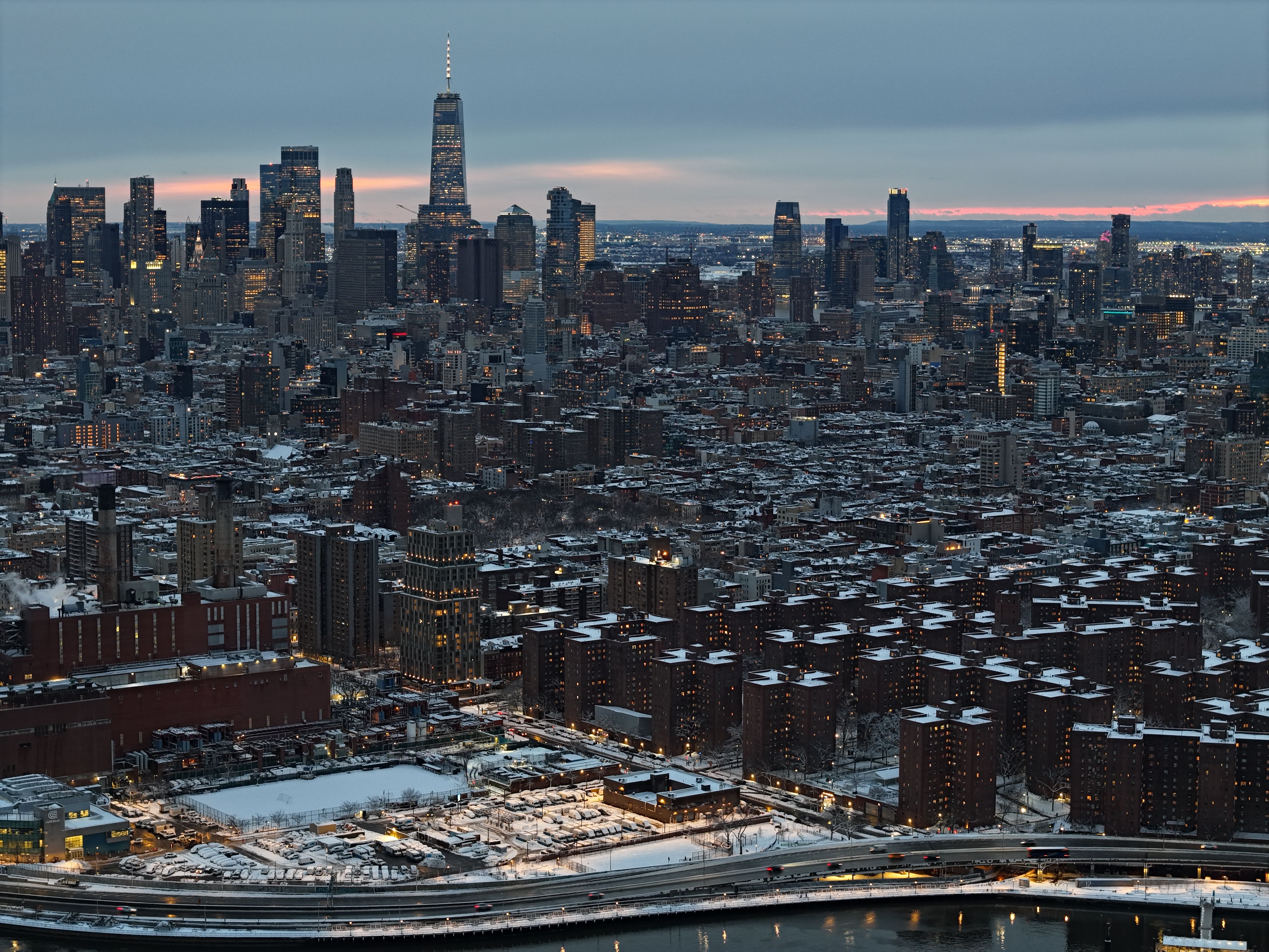Unbeatable Deluxe Manhattan Helicopter Tour Review: The Ultimate 18-Minute NYC Adventure Review 2026 - Dramatic twilight aerial view of New York City's skyline, covered in winter snow.