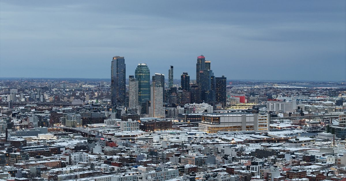 Aerial view of Long Island City skyline in winter with snow-covered buildings.