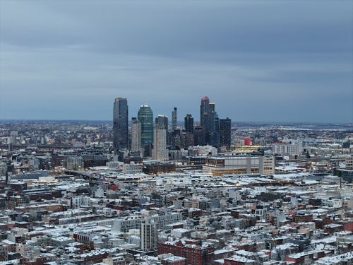 Free Aerial view of Long Island City skyline in winter with snow-covered buildings. Stock Photo