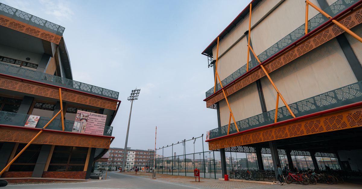Modern sports complex architecture with vibrant facades in Delhi, India.