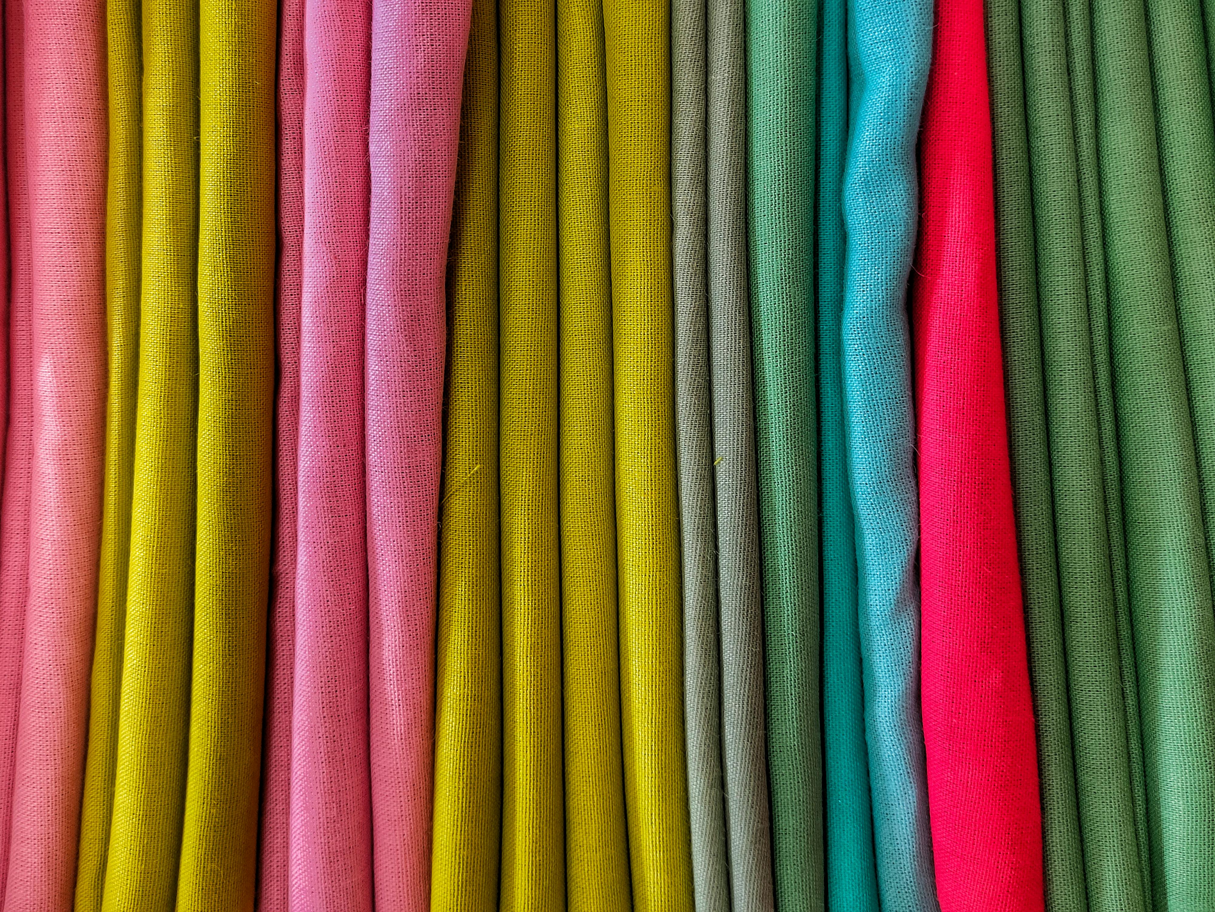 Free Bright and colorful textile fabric folds in a vibrant pattern, highlighting a variety of hues. Stock Photo