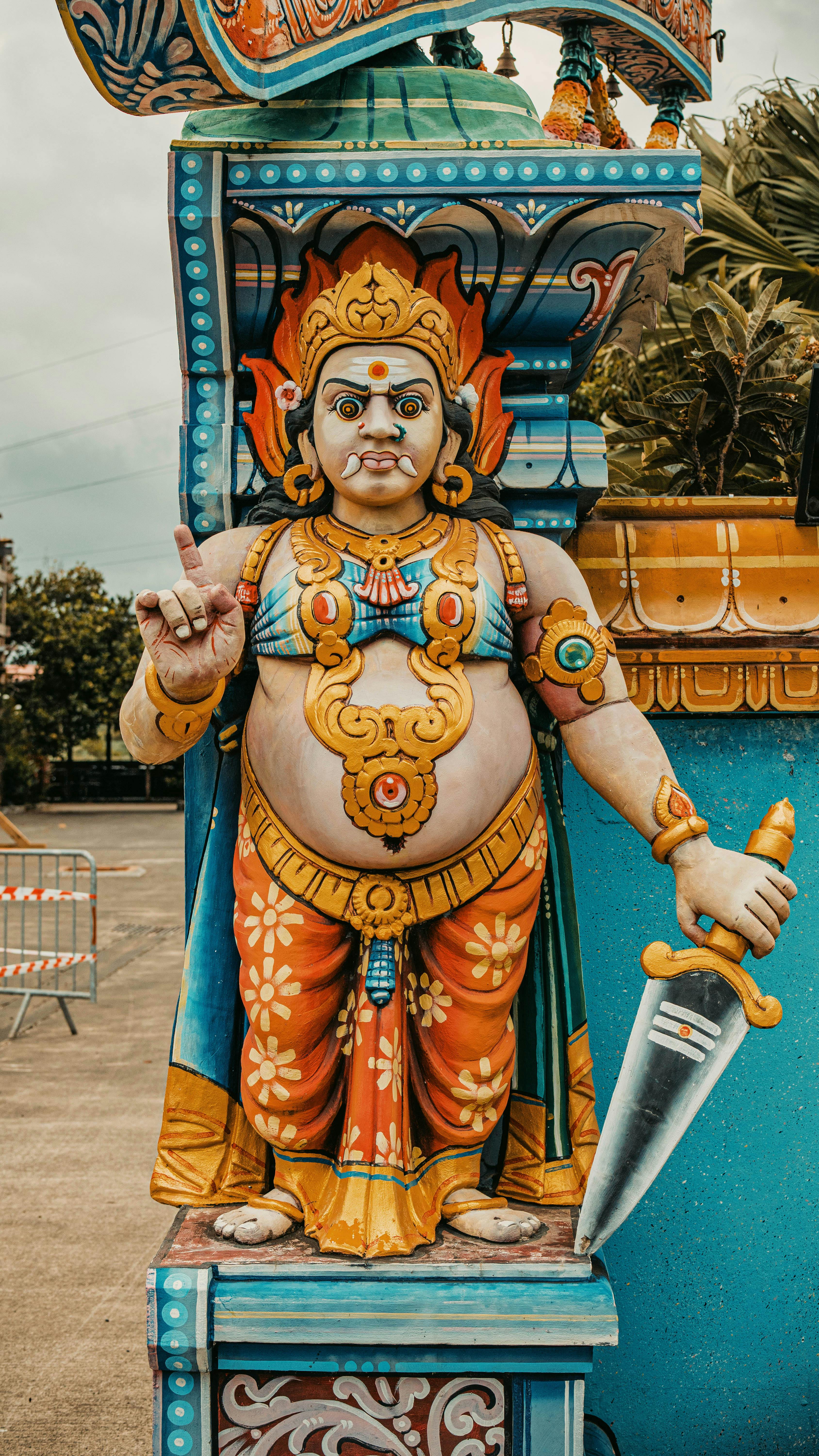 Vibrant Hindu deity statue captured outdoors in La Réunion, showcasing intricate traditional art.
