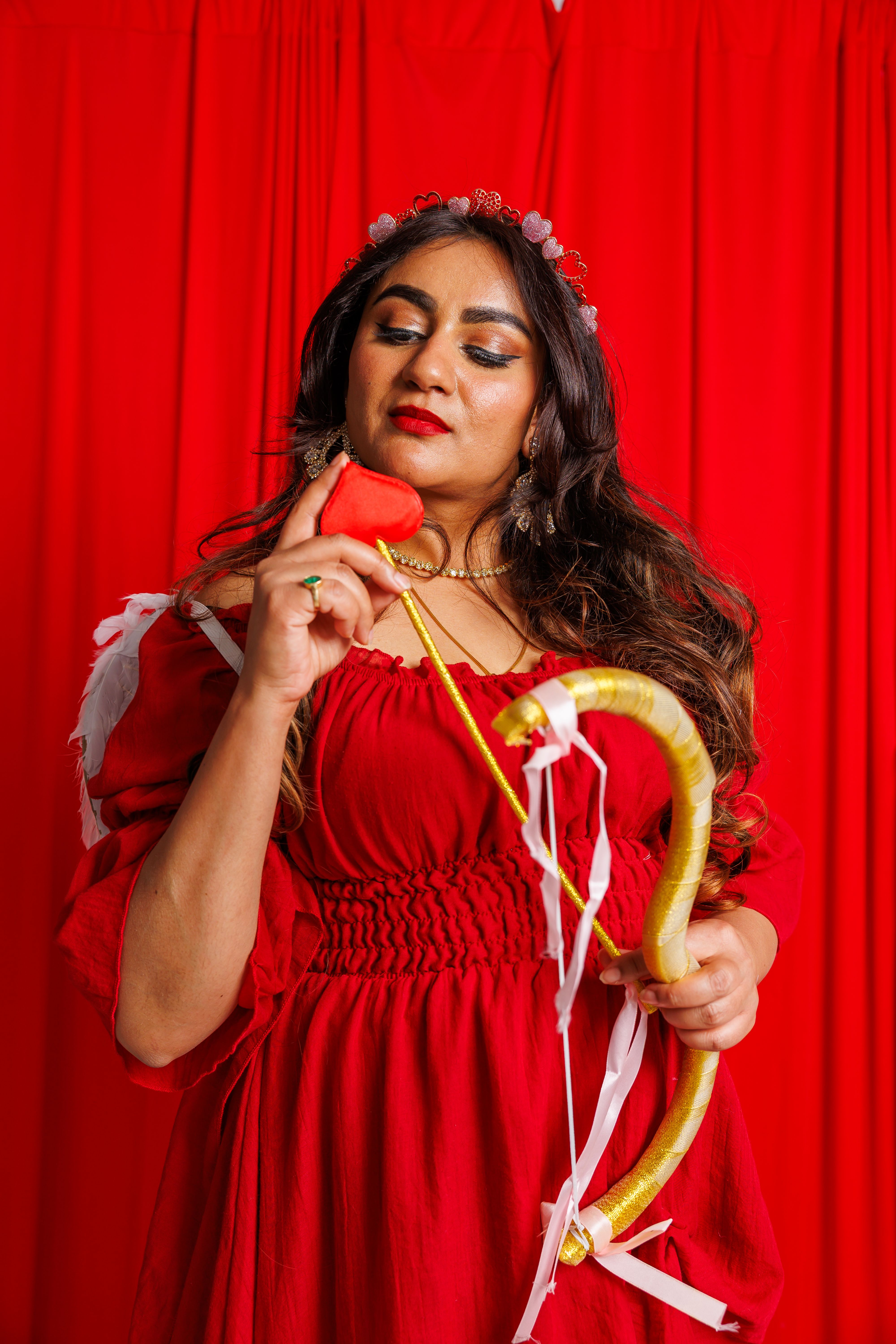Woman in Red Dress Holding Bow and Arrow · Free Stock Photo