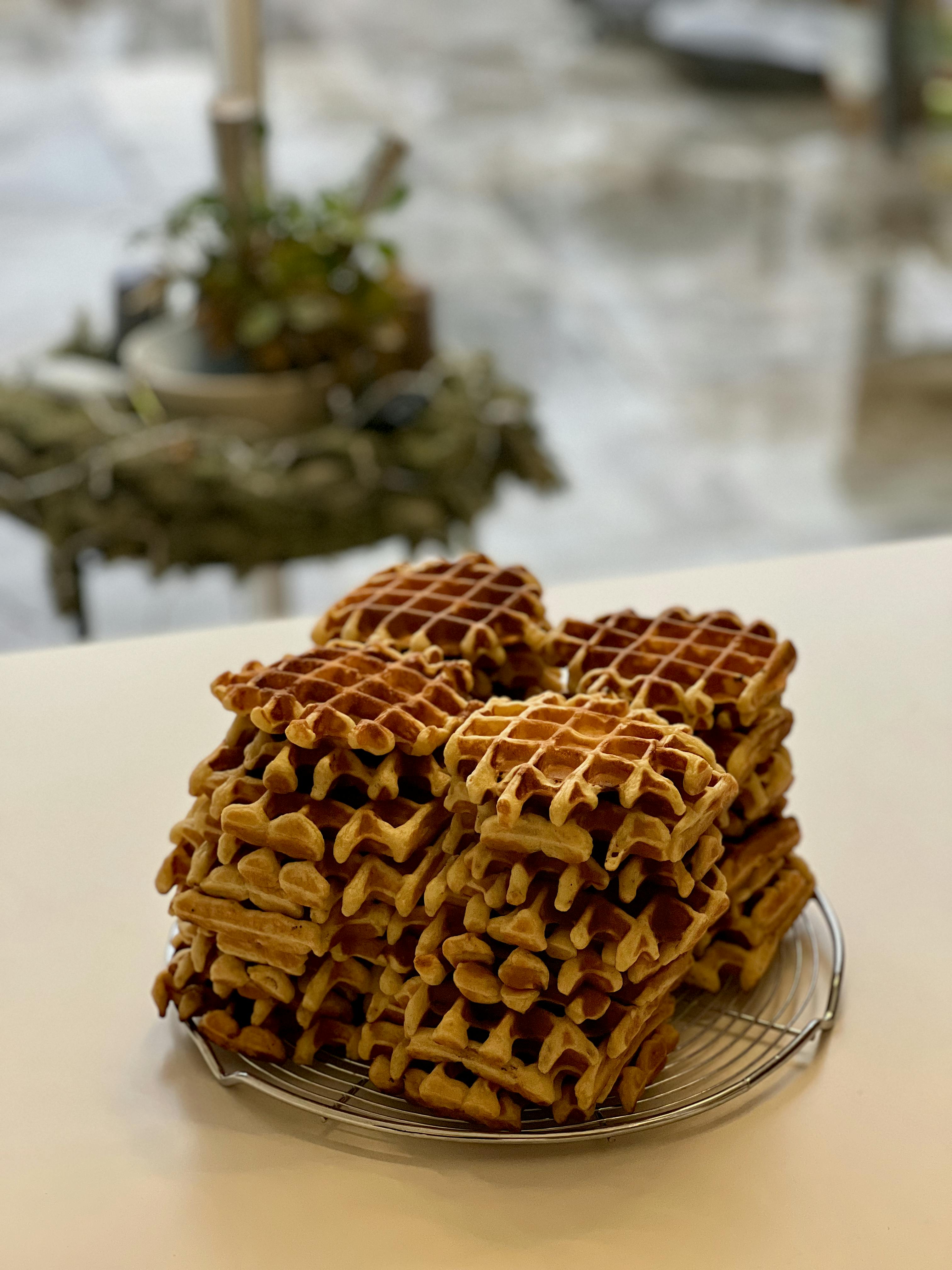 бесплатная Вкусные золотисто-коричневые вафли аккуратно сложены на решетке и готовы к подаче. Стоковое фото