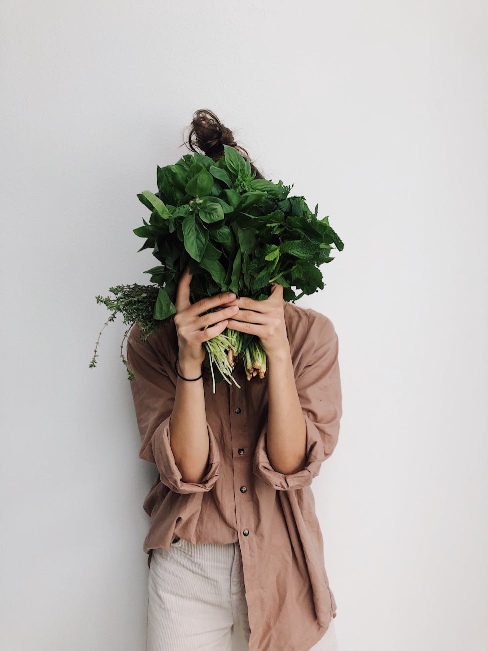 woman holding herbs for respiratory health