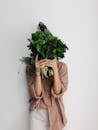 Person Holding Green Vegetables