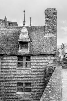 Black and white photo of Mont-Saint-Michel's medieval stone architecture in France.