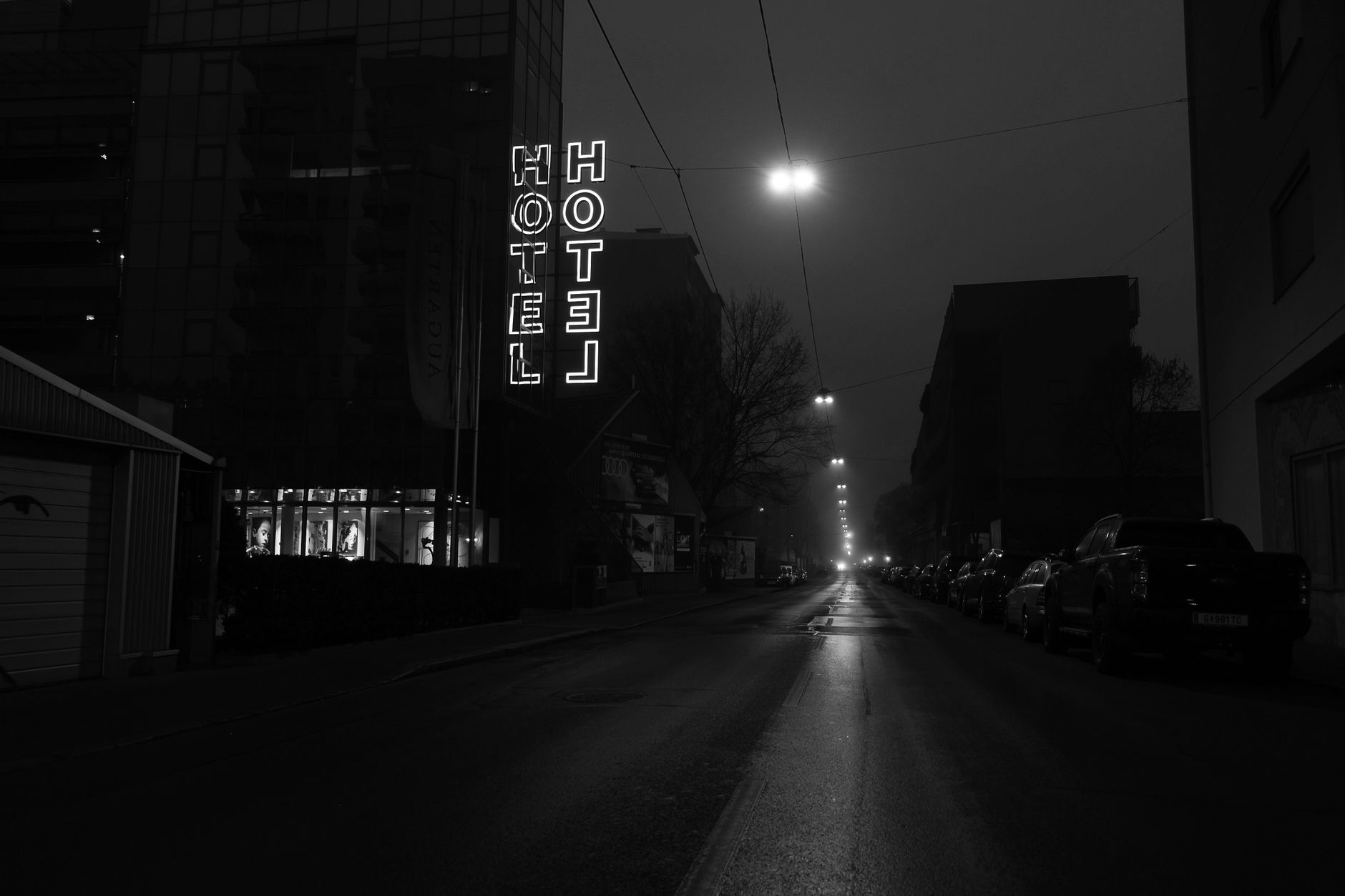 Hotel entrance at night with taxi waiting outside