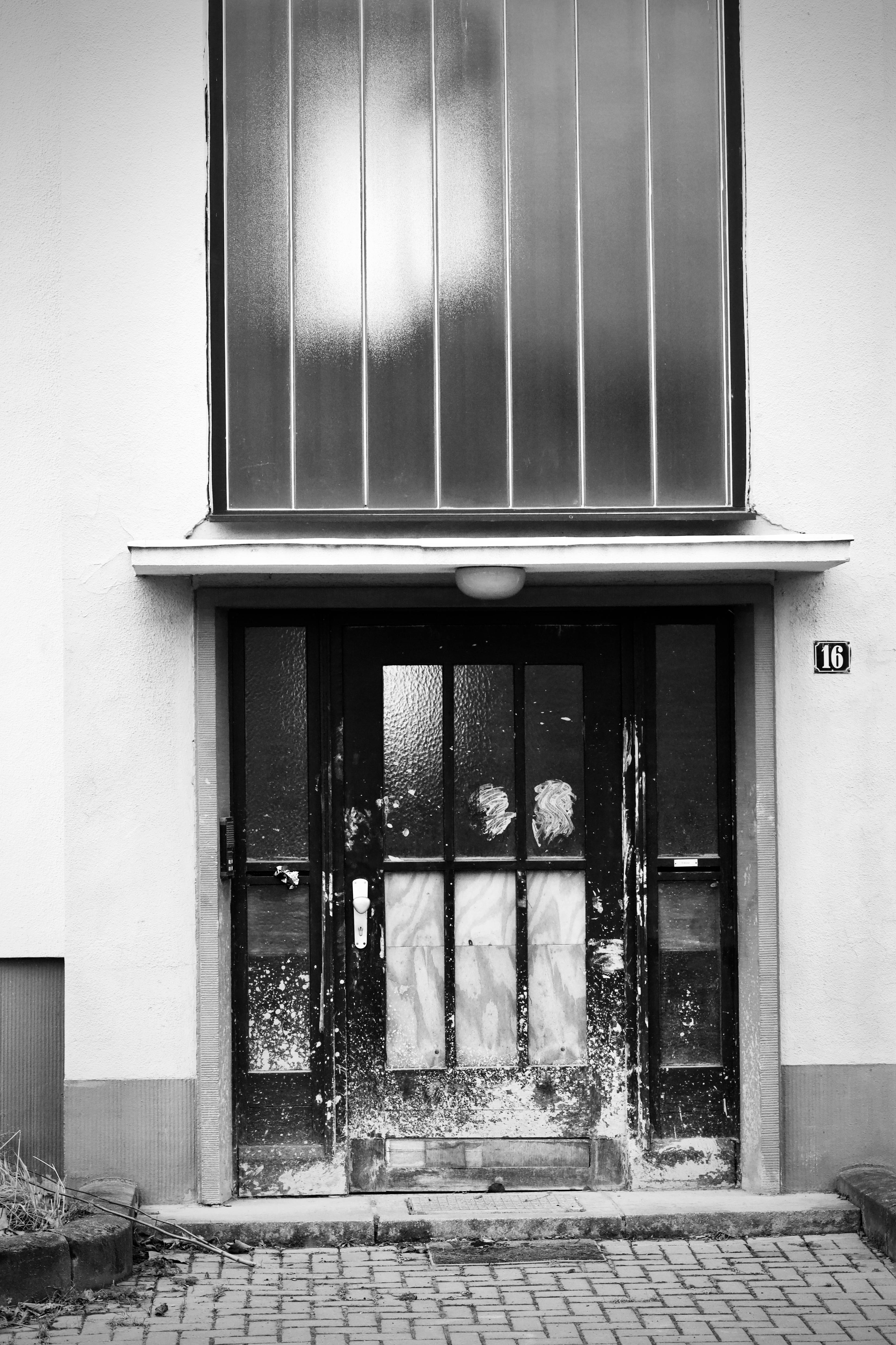 無料 ガラスパネルを備えた近代的な建物の玄関ドアの白黒写真、番号 16。 写真素材