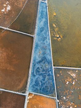Stunning aerial shot of colorful salt fields showcasing unique patterns and textures in Vietnam.