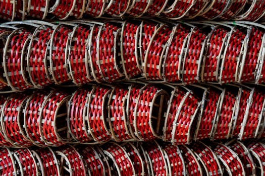 Intricate red and bamboo baskets stacked neatly, showcasing traditional Vietnamese craftsmanship.