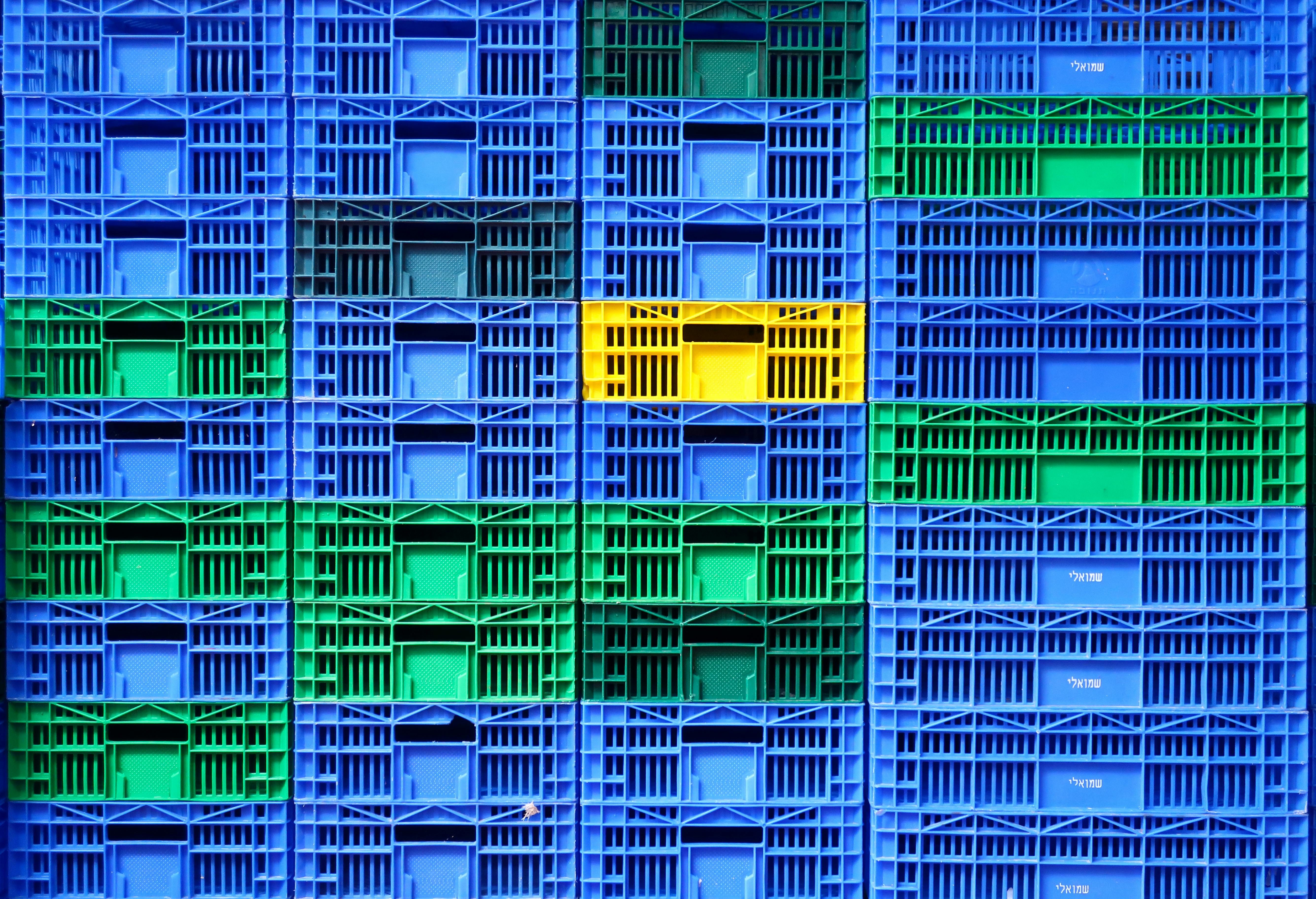 Free Colorful plastic crates stacked in a vibrant pattern at Tel Aviv market. Stock Photo