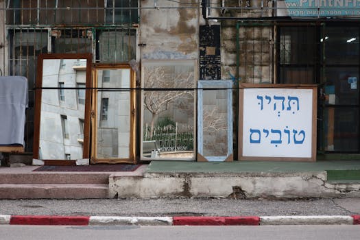 Decorative mirrors displayed outdoors in an Israeli street setting, adding a unique urban charm.