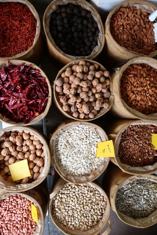 Free Assorted spices and nuts in burlap sacks at a Tel Aviv market, Israel. Stock Photo
