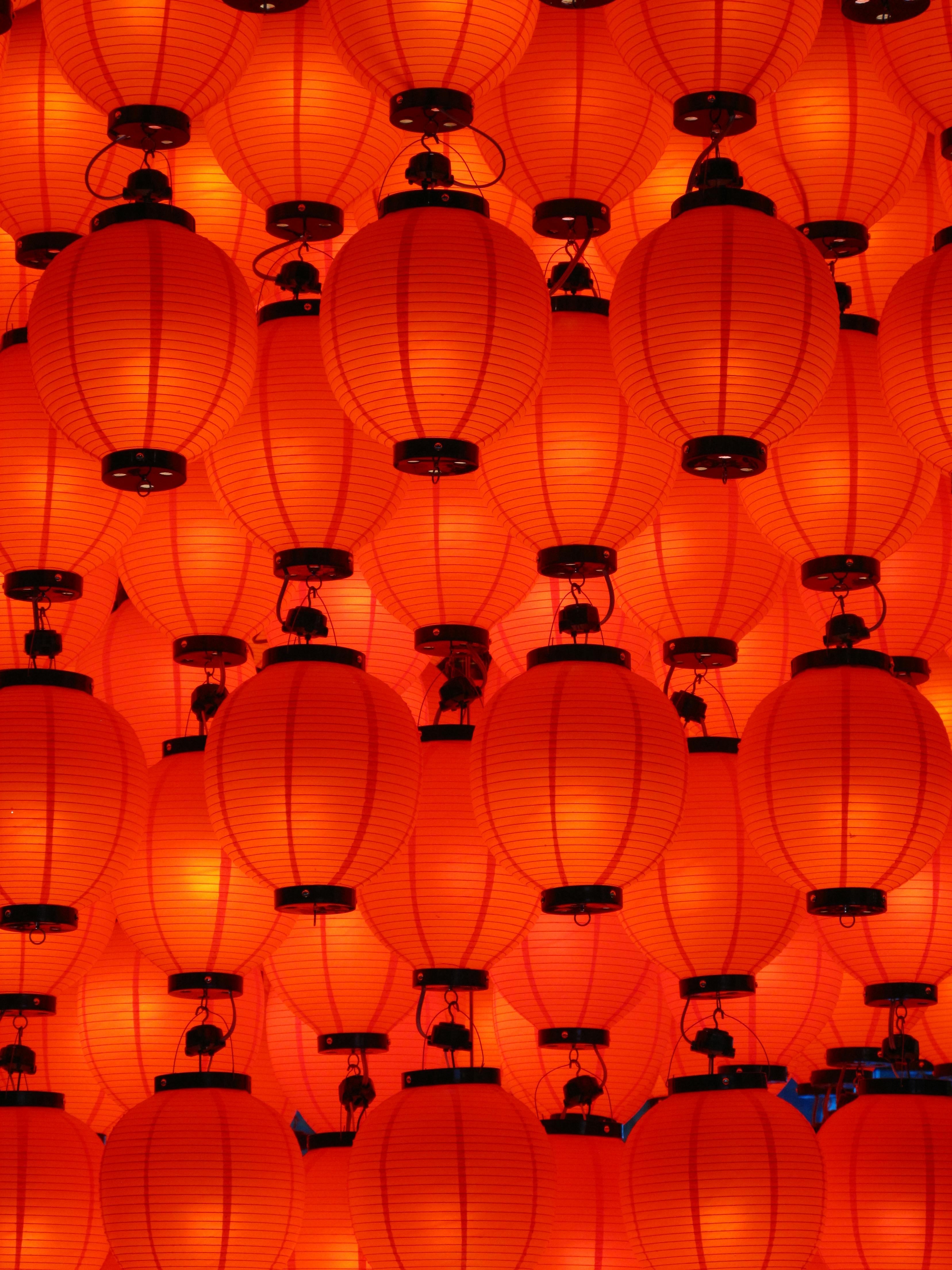 Free Colorful red lanterns create a warm, vibrant atmosphere in a traditional Japanese setting at night. Stock Photo