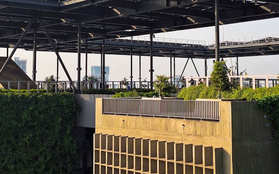 A rooftop garden integrated into a modern steel and concrete structure, showcasing urban greenery.