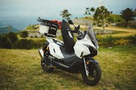 White Scooter Parked in Scenic Outdoor Location