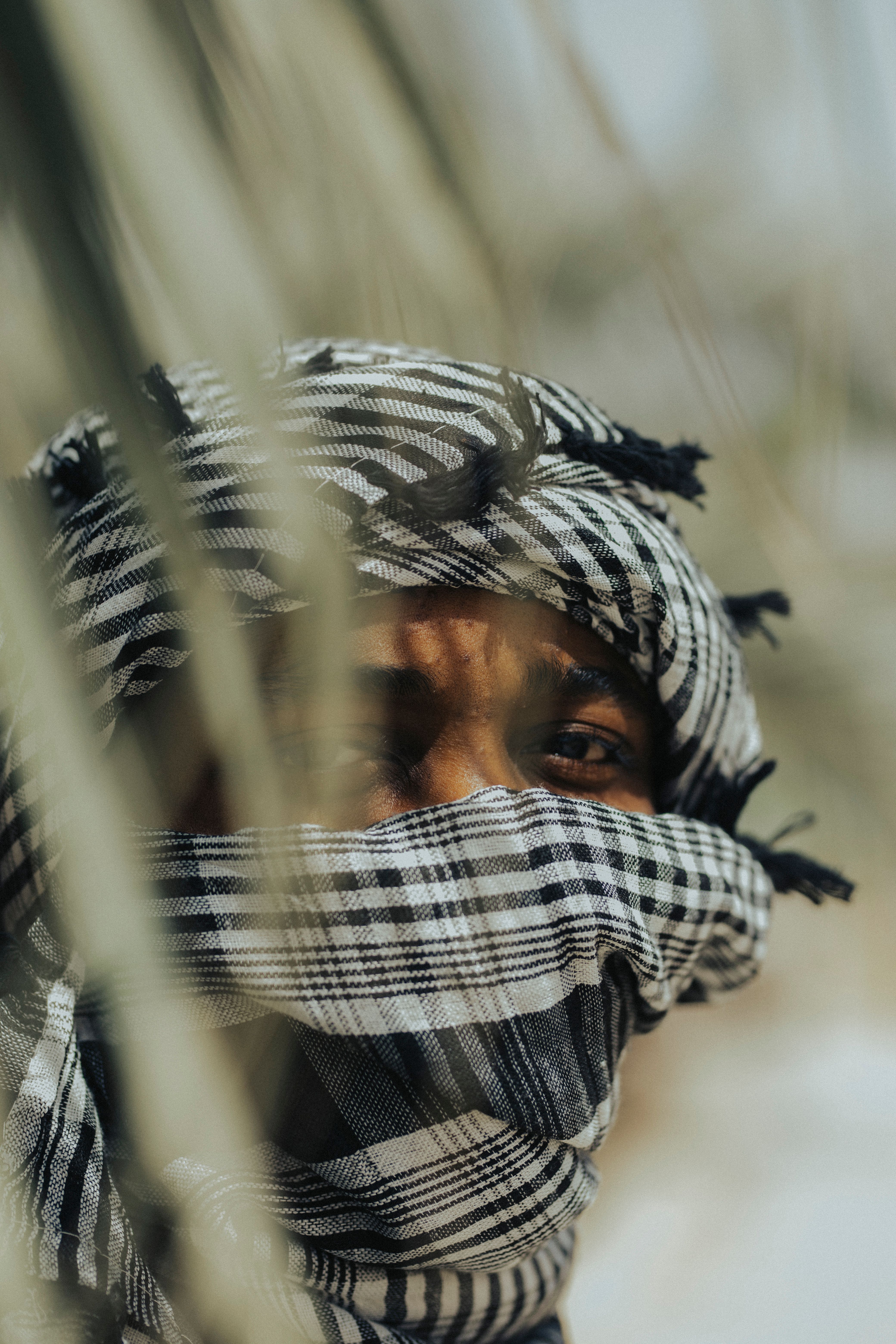 Close-up of a person in Kano, Nigeria, wearing a traditional black and white scarf.