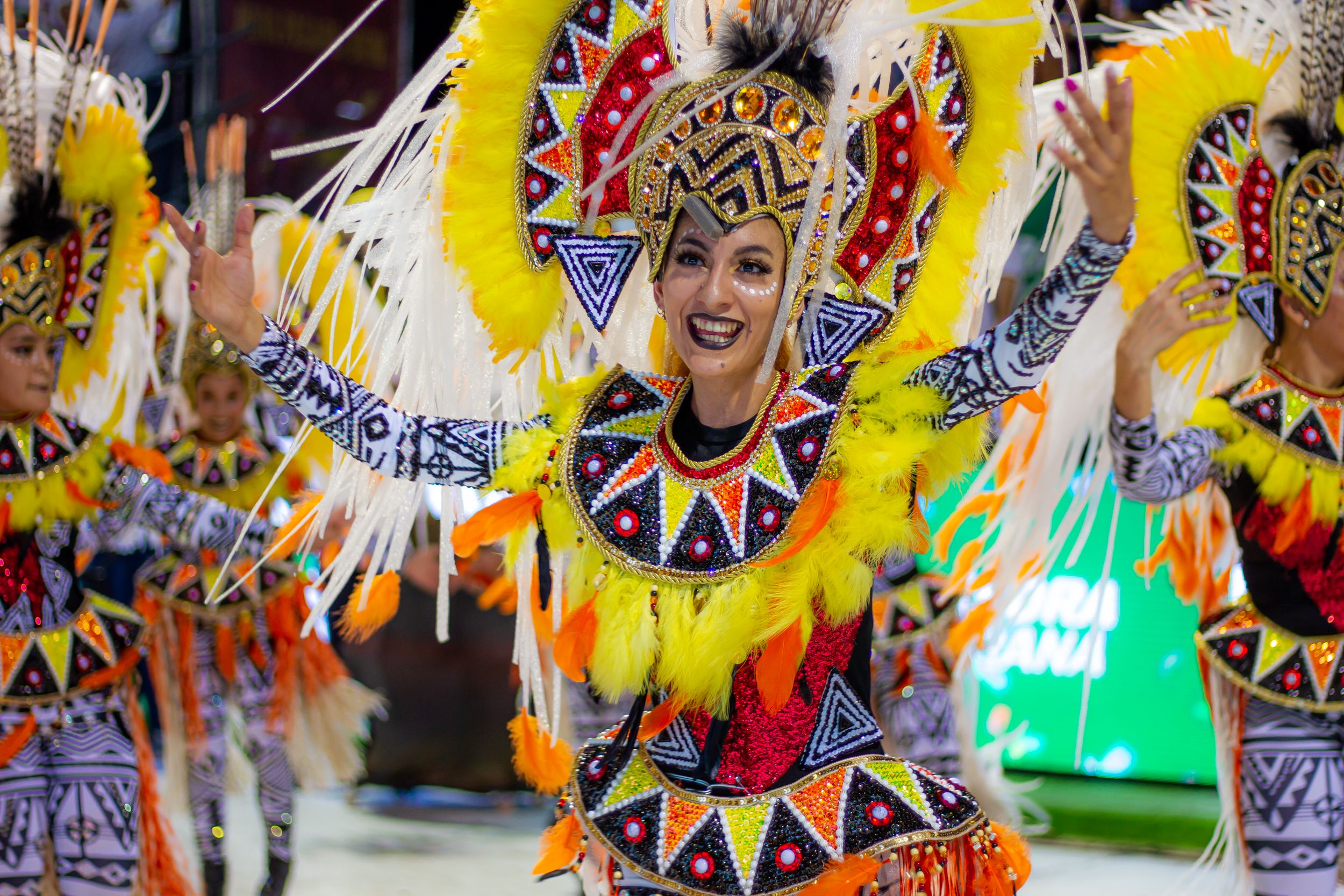 Colorful traditional carnival parade with dancers in elaborate costumes and masks celebrating in historic streets