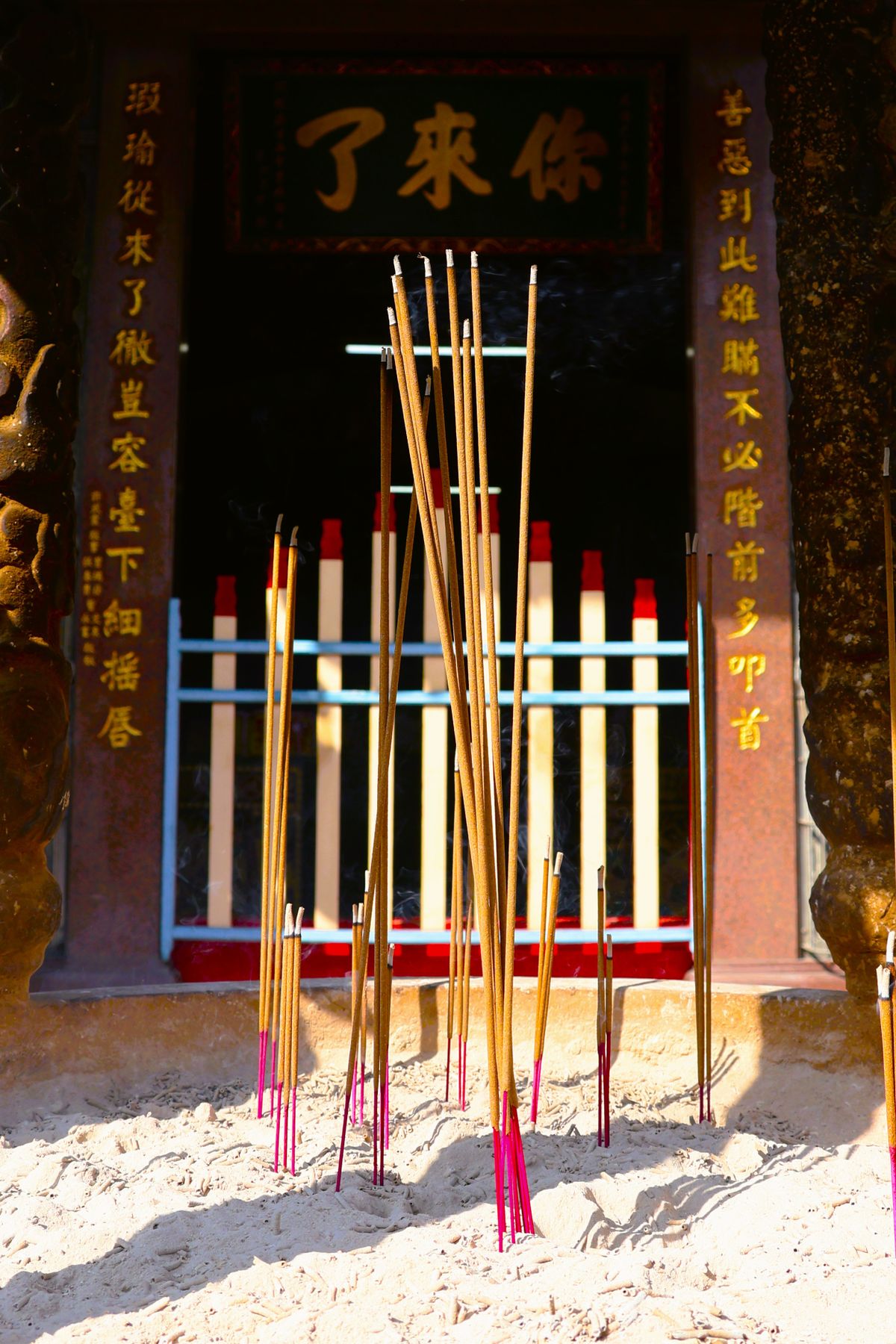 Incense sticks burning at the entrance of a Taiwanese temple