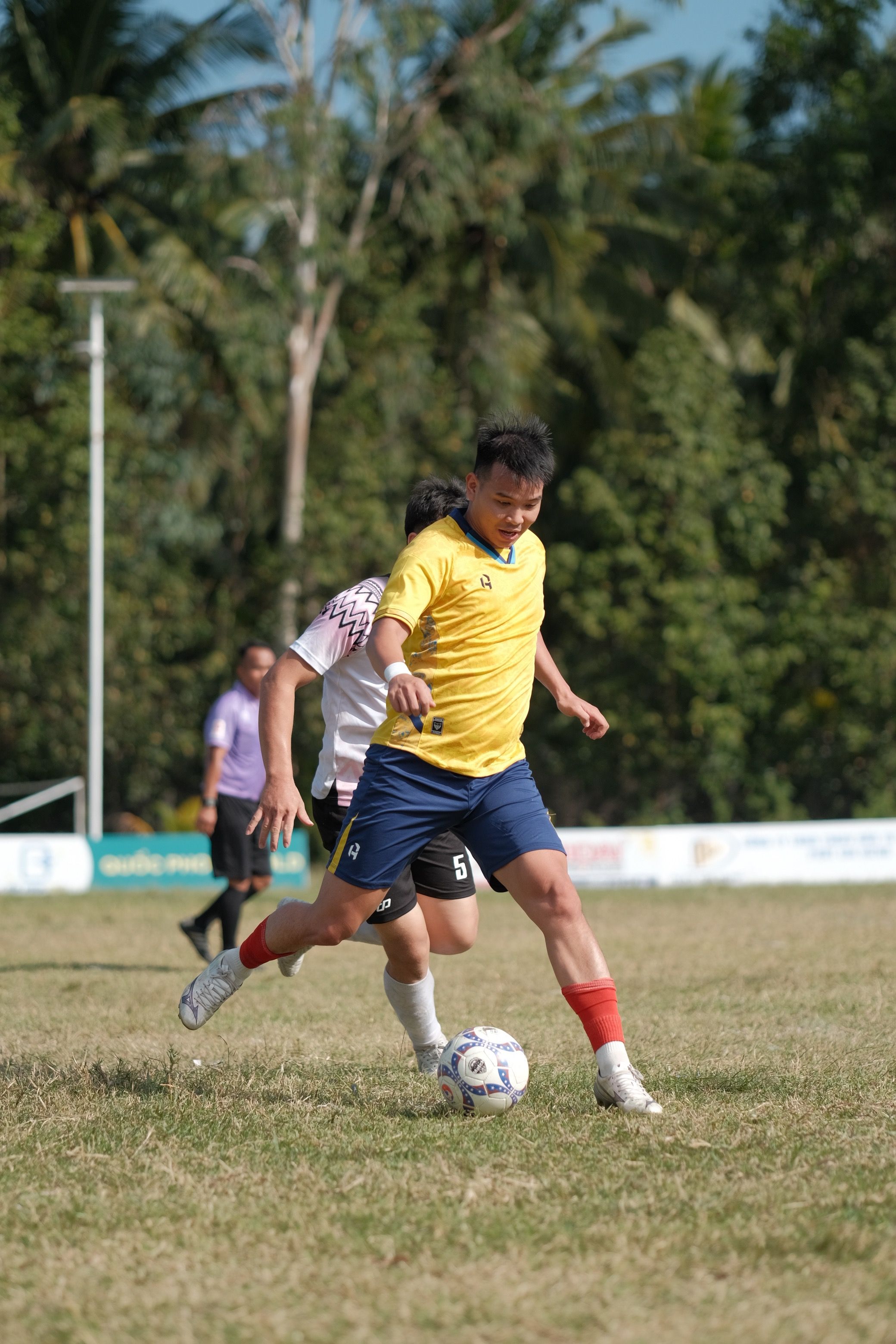 Intense Soccer Match in Sunny Outdoor Field