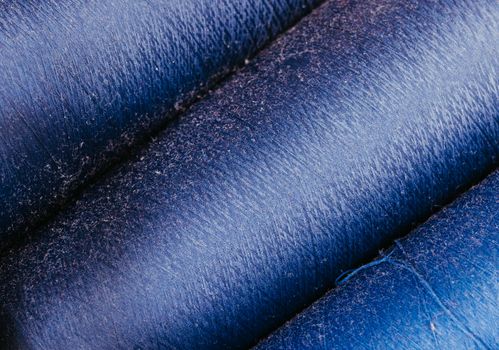 Detailed close-up of blue fabric rolls showcasing texture and pattern in vivid blue tones.