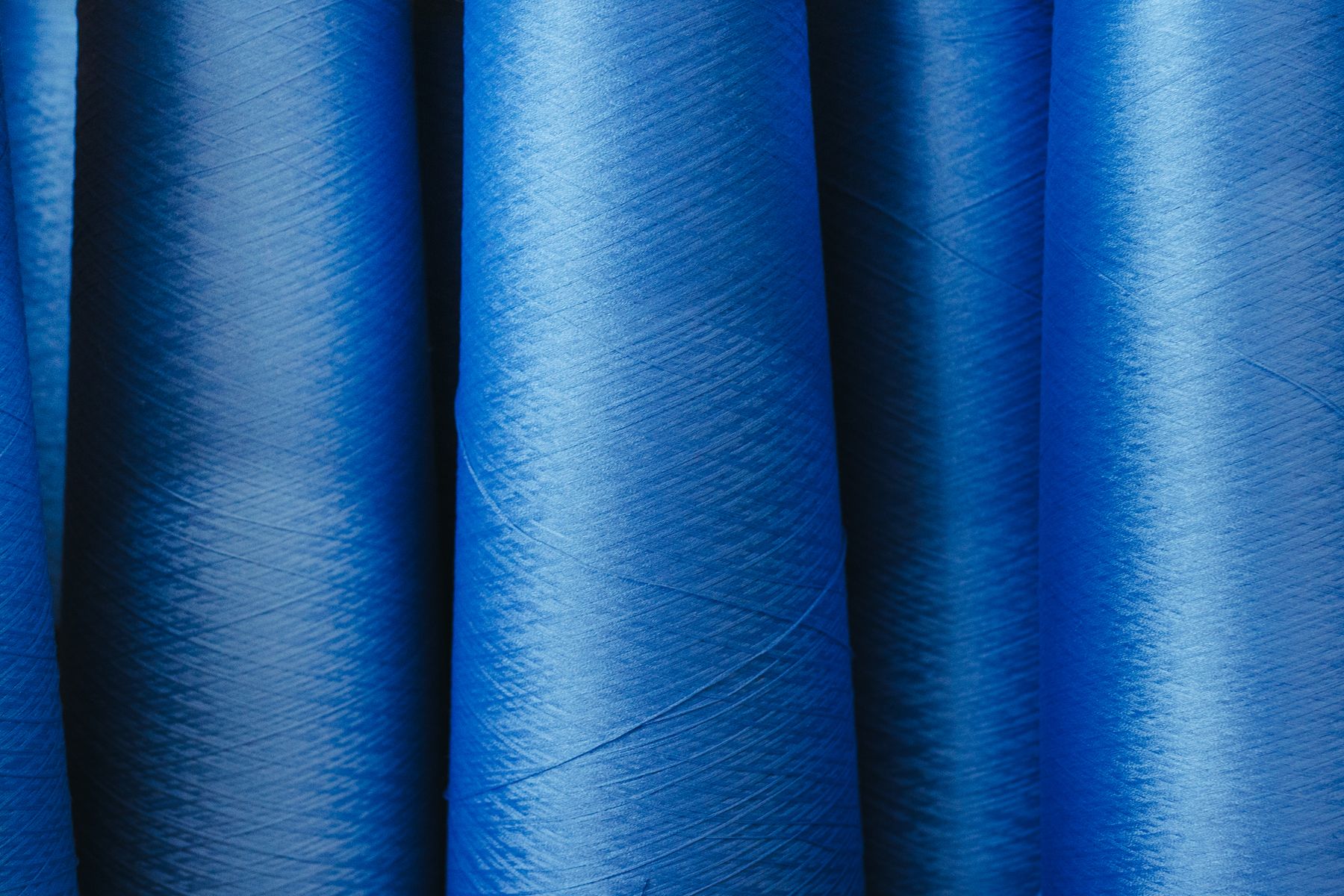 Rows of yarn spools in a textile facility