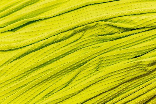 Detailed close-up of bright yellow textured fabric, showcasing intricate patterns and vivid color.