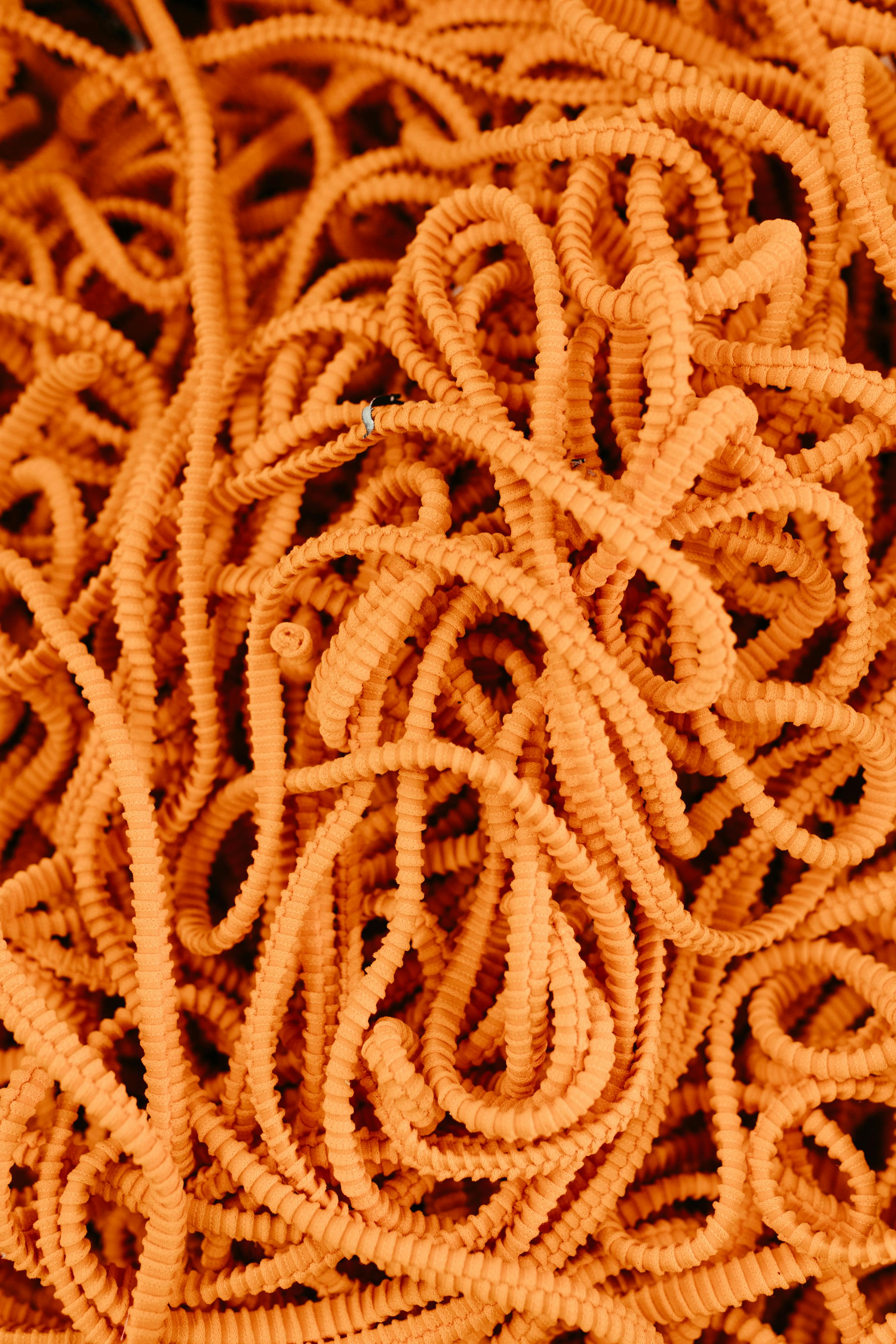 gratis De levendige oranje kabels creëren een dichte, verwarde textuur, perfect voor abstracte achtergronden. Stockfoto