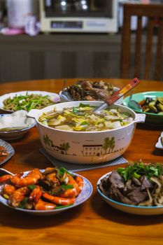 Mouth-watering spread of traditional Asian dishes including soup, seafood, and vegetables.